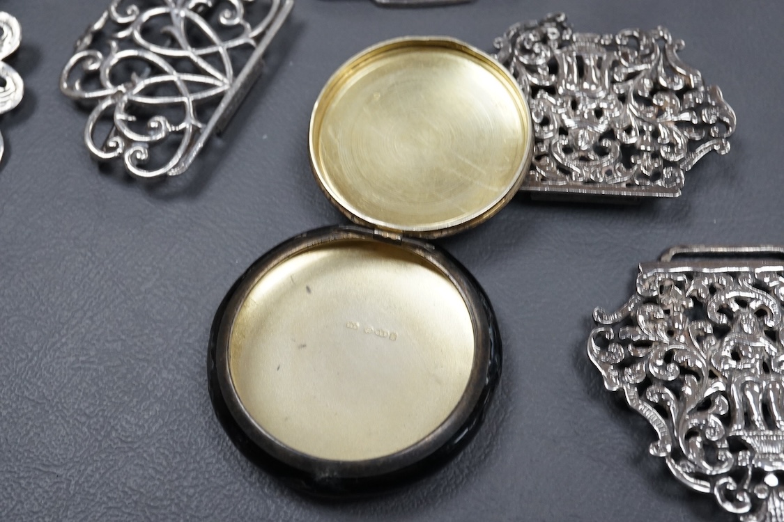 A group of small collectable silver including a white metal dragon menu holder? by Wang Hing, 92mm, two 19th century caddy spoons, three assorted belt buckles and a 1920's silver and enamel pill box(a.f), import marks fo